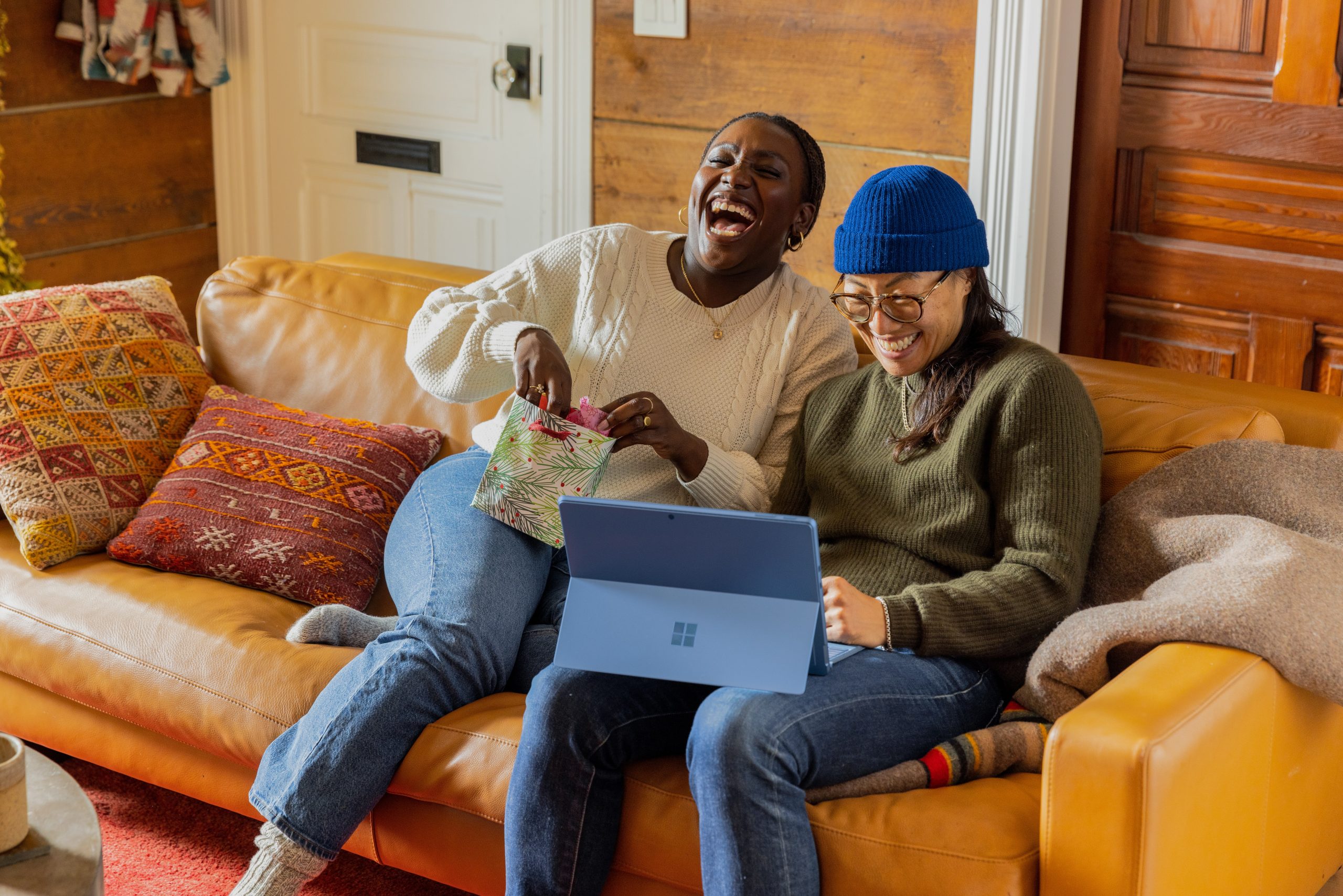 Friends laughing on the couch